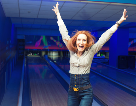 Woman Excited About Bowling a Strike